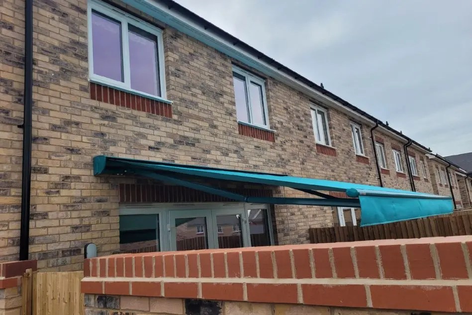 Side view of Weinor Topas awning extended over patio in Ely