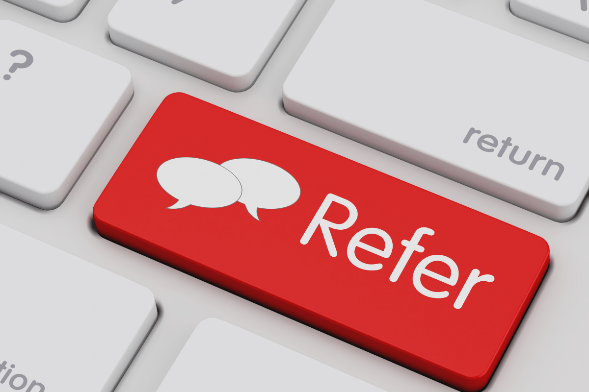 A keyboard with a red Refer button