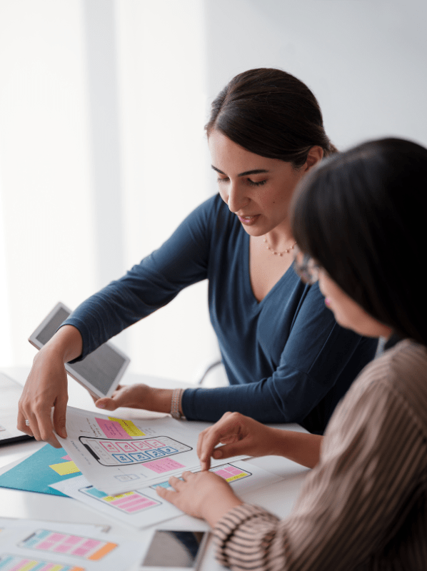 Two women working with papers