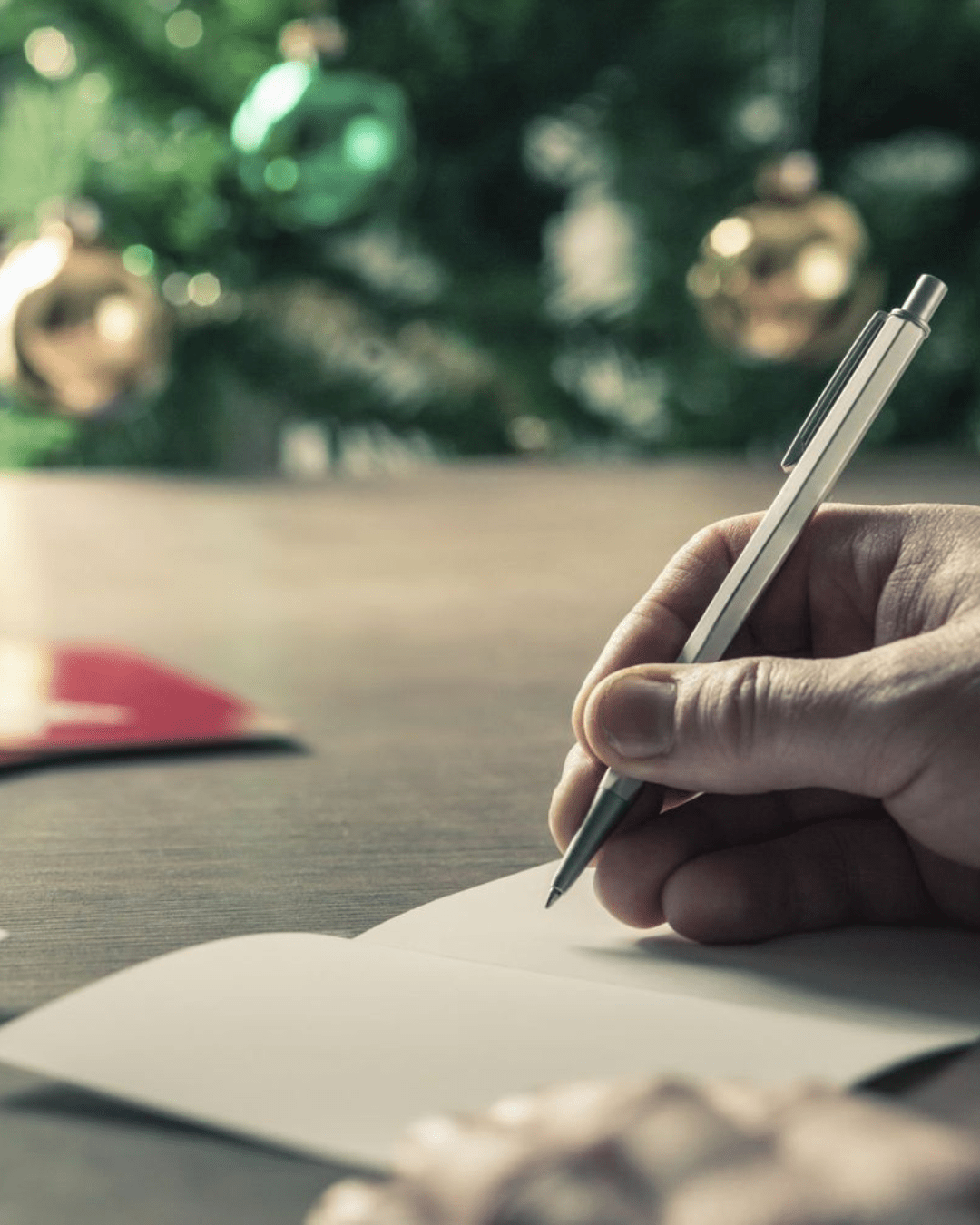 Someone writing a handwritten note for Christmas