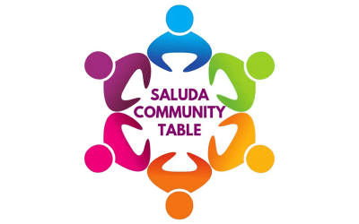 Colorful abstract figures forming a circle around the words 'saluda community table' in the center, symbolizing a community gathering or event logo.