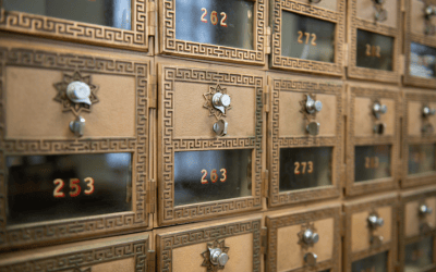 Antique wooden cabinet with many small numbered drawers and metal knobs, glowing numbers visible on front edges.