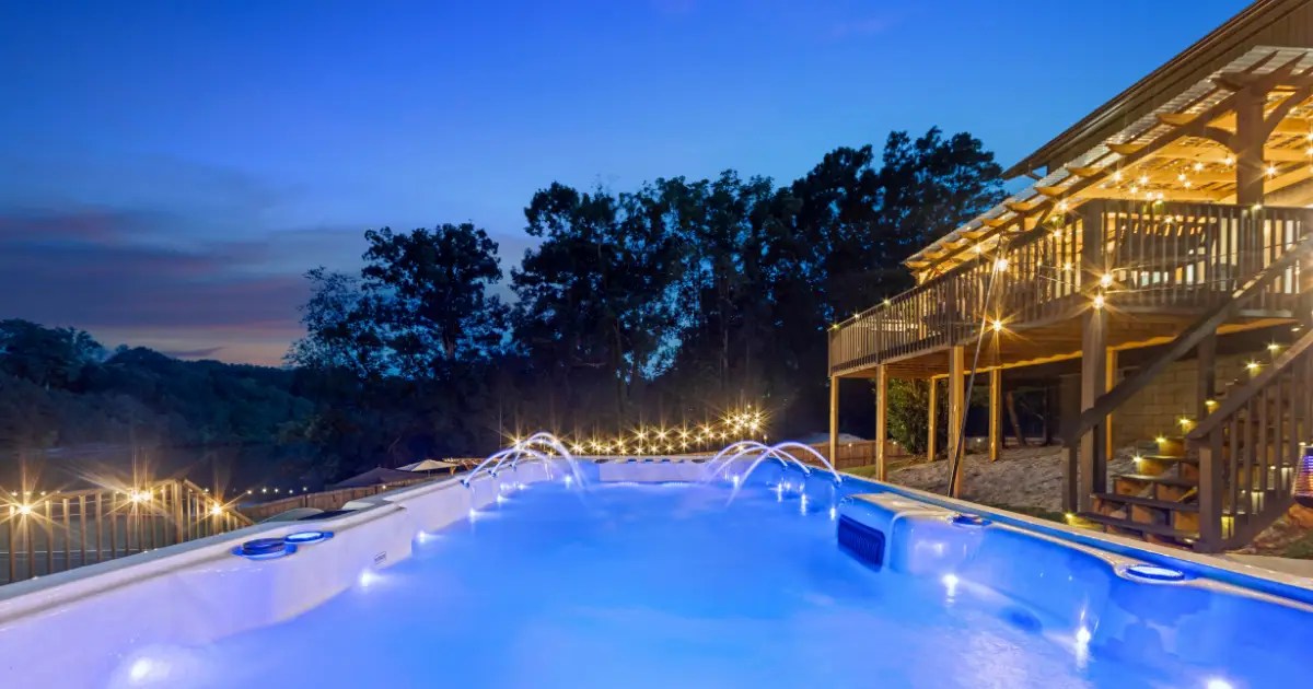 Heated aquatic therapy swimspa under custom pergola at Saluda Lake Retreat
