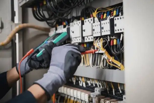 Electrical panel upgrade in Alexandria VA with an electrician testing wiring inside a breaker panel