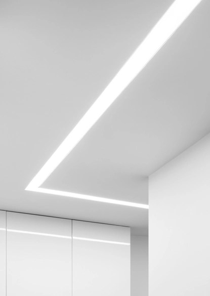 Minimalist white ceiling featuring a recessed linear LED light installation in a Springfield VA home, showcasing a clean, modern aesthetic.