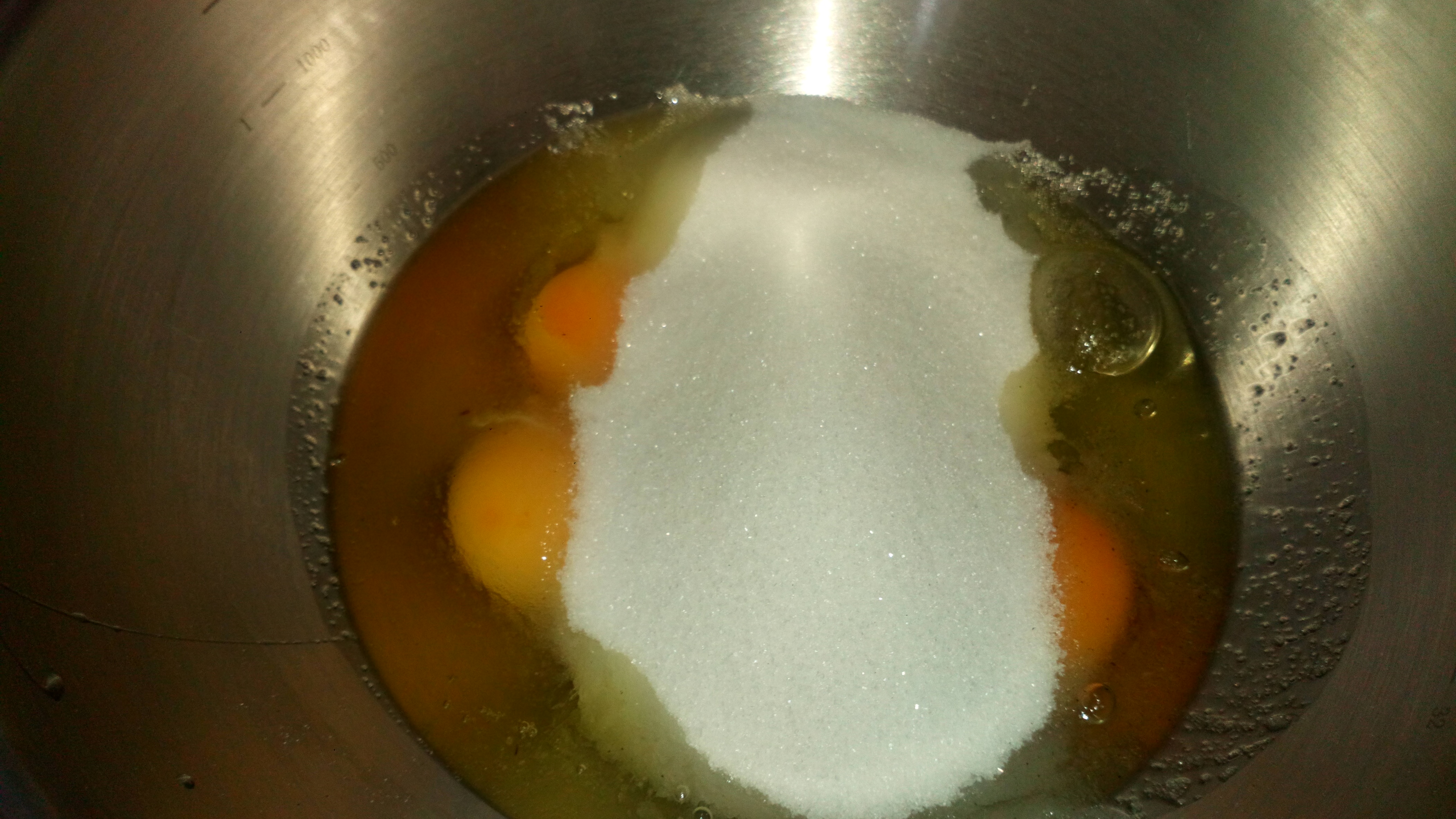Dans un saladier inox, à part, mettre les œufs et l'autre partie de sucre en poudre. In inox ball, put eggs and the other part of sugar