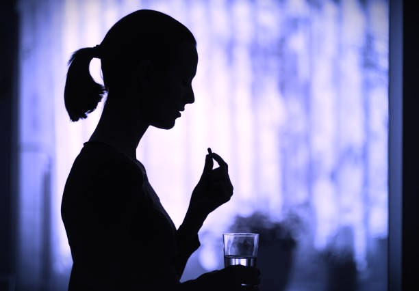 Woman taking a pill medicine.