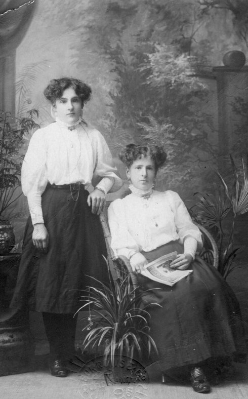 Elsie Holt(Taylor) with sister May Holt (Edmunds) on the back of the card: Dear Lizzie, received PC. I did not send Maud my photo. Elsie sent it to her as I never had any myself. Elsie paid for them all. I had to get you one copied. Don't forget to send me one of Jim's Bert, as the one you sent Mum was lovely. We are leaving Saturday if fine. Hope we have better luck this year. Don't forget to drop me a line while we are away. Love to self and the two children. Hoping they are well. I remain your loving sister, May.