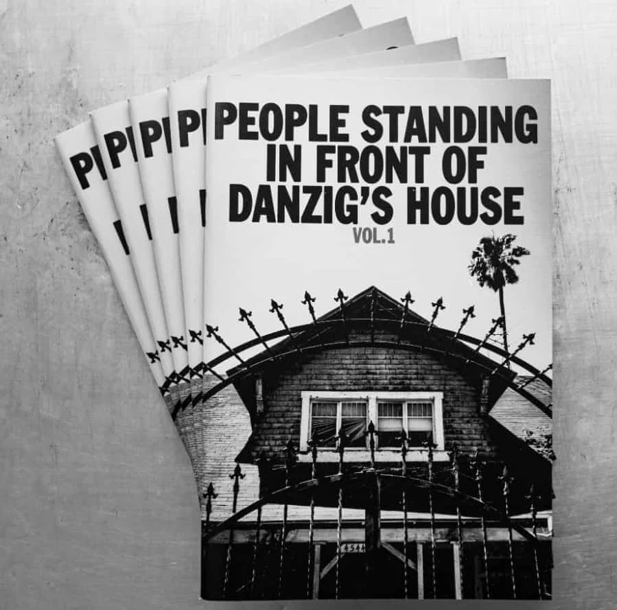 Explore the quirky People Standing In Front of Danzig's House, a zine-style book featuring black-and-white prints of fans outside Glenn Danzig's gothic home!