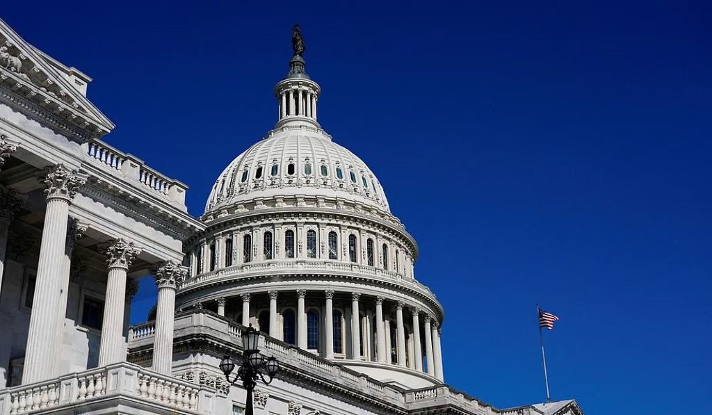 The U.S. Capitol dome and neoclassical portico against a clear blue sky, with its columns and lanterns visible.【informative】
