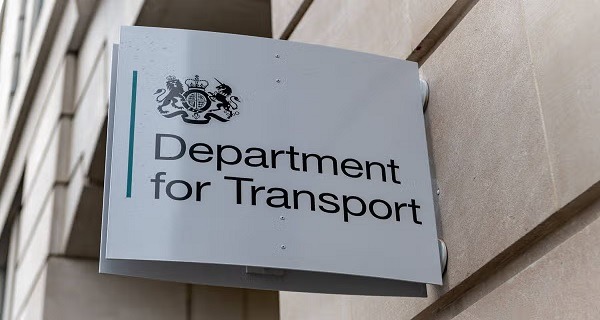 Outdoor sign on a building reading 'Department for Transport' with a crest at the top left of the panel.