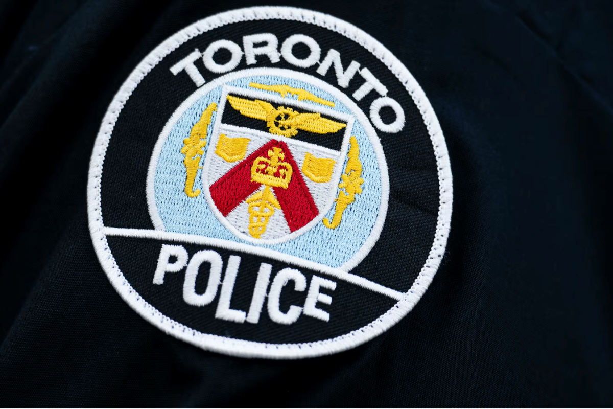 Toronto Police patch detail with crest and circular 'TORONTO POLICE' insignia on dark fabric
