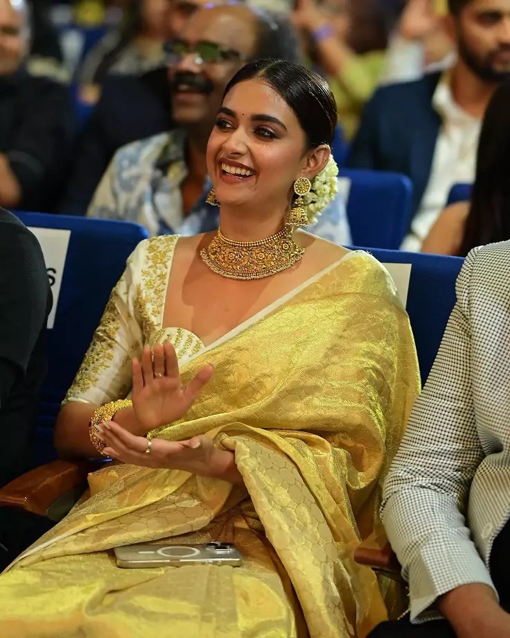 Keerthy Suresh in a stunning golden saree with intricate jewelry at SIIMA 2024.