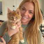 ginger maine coon kitten with red headed owner