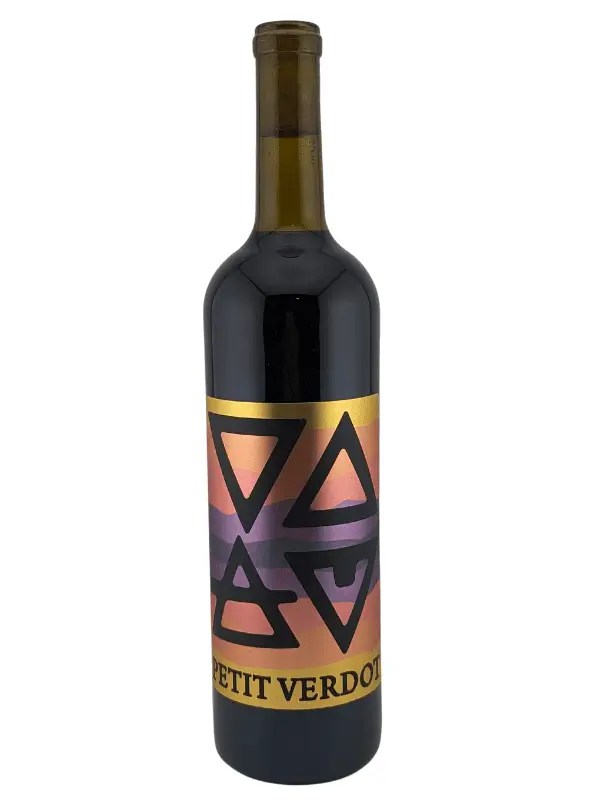 A bottle of red wine labeled Petit Verdot with a colorful, sunset-inspired label featuring bold black geometric shapes. The bottle is standing upright on a white background.