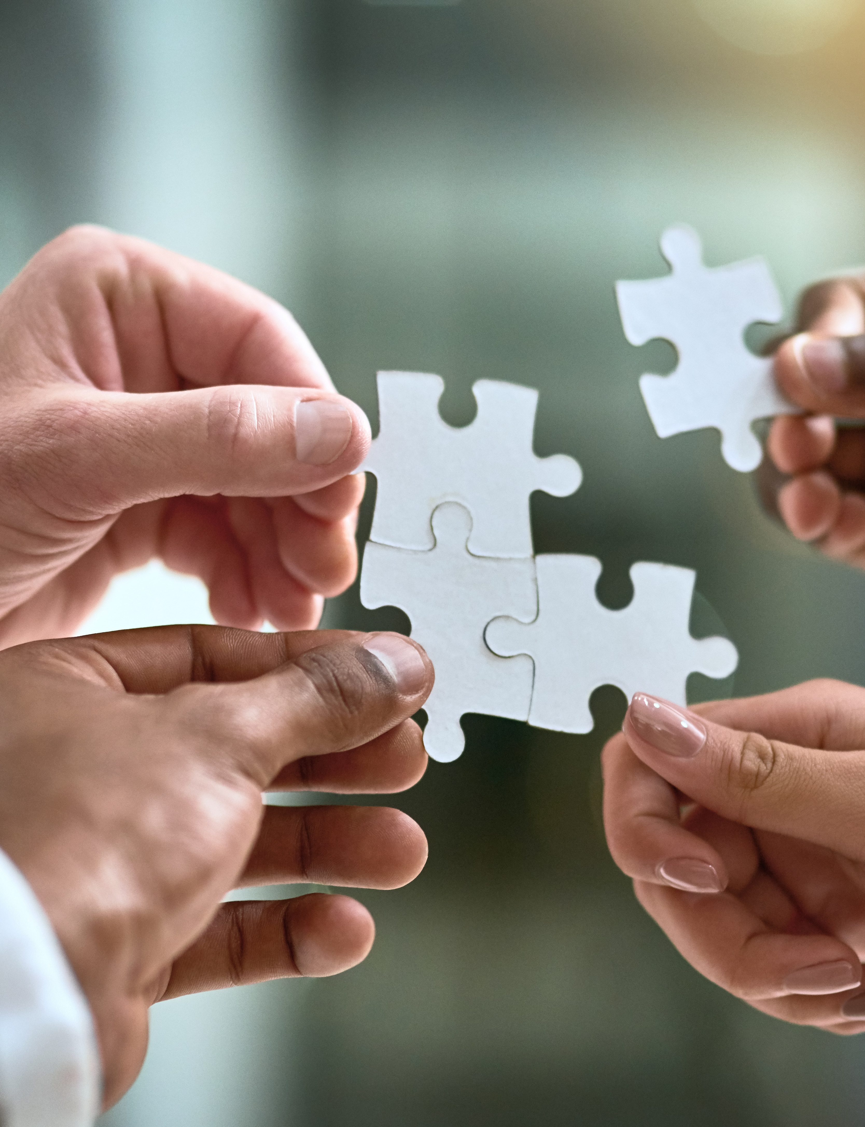 Puzzle, business hands and group of people for solution, teamwork and goals, integration or workflow success. Team building, games and development of person problem solving, synergy or collaboration.