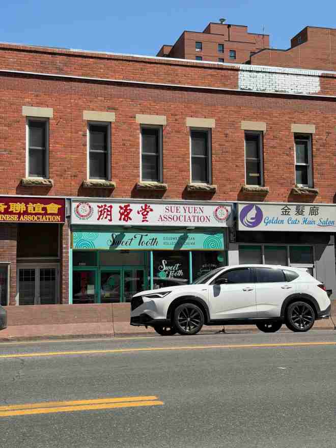 brick building with car passing