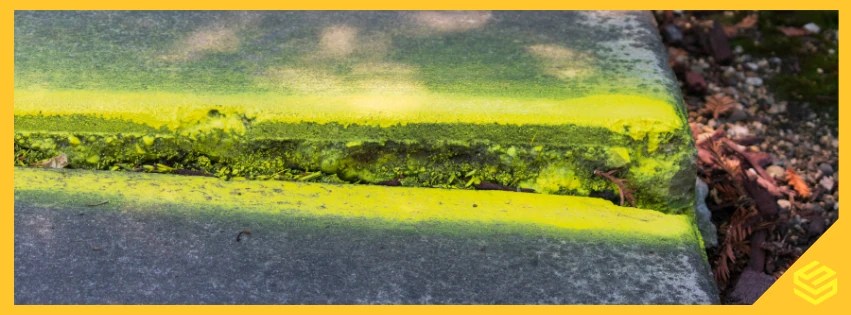 Sunken concrete slab showing settlement and a visible void beneath the surface.