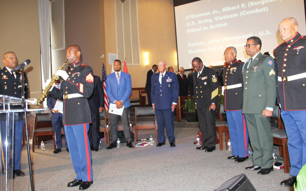 USMC, Sgt William Farmer plays "Taps" in memorial service.