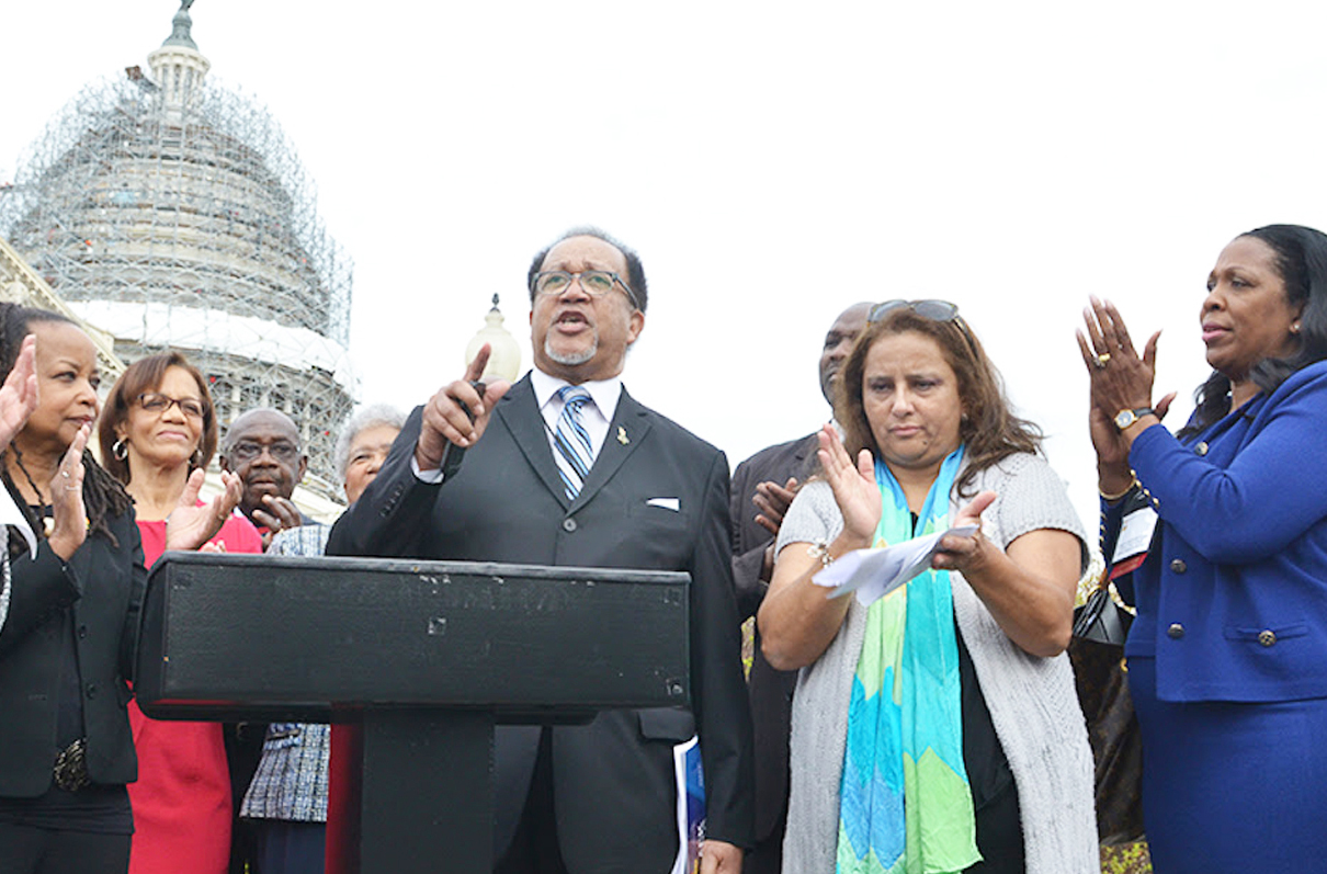 NNPA President Benjamin Chavis speaks outside of the U.S. Capitol during a joint press conference between NNPA and NAHP. The press conference was attended by Washington, D.C. Congresswoman Eleanor Holmes Norton (far left). (Freddie Allen/AMG/NNPA)