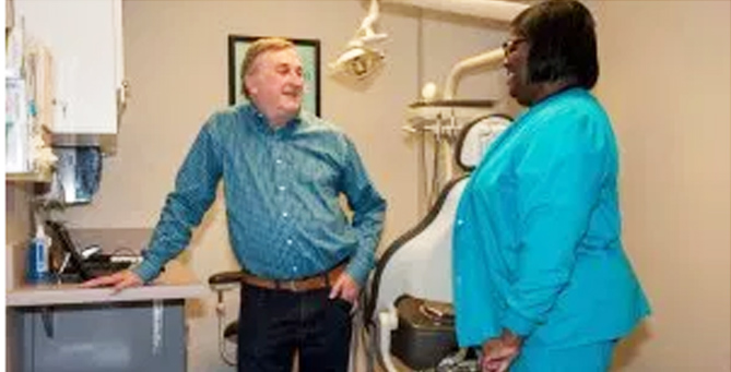 Tim Young, CEO of Open Health Clinic and HIV/AIDS Alliance for Region Two Inc, talks with nurse at the Baton Rouge based clinic.