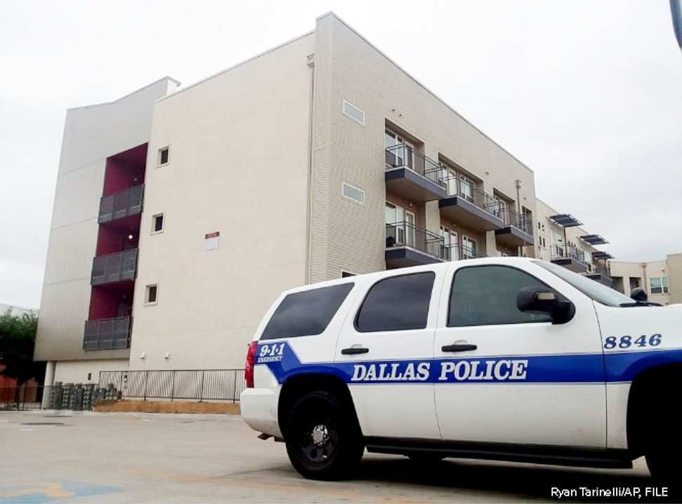 A Dallas Police vehicle is parked near the South Side Flats apartments, Sept. 10 2018, in Dallas.