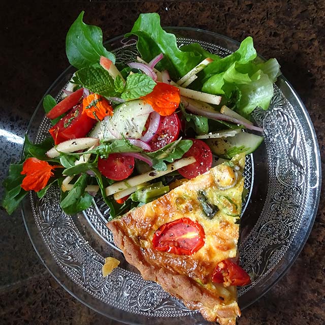 Fresh salad and edible flowers add colour and flavour to the plate.