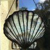Stained glass scallop hanging on window