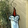 Stained glass xmas candle in window