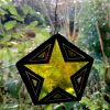 Yellow stained glass xmas star in window