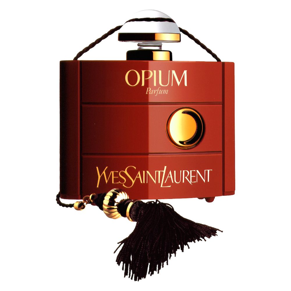 A red and gold perfume bottle labeled 'OPIUM Parfum' by Yves Saint Laurent, featuring a round cap and a decorative tassel.