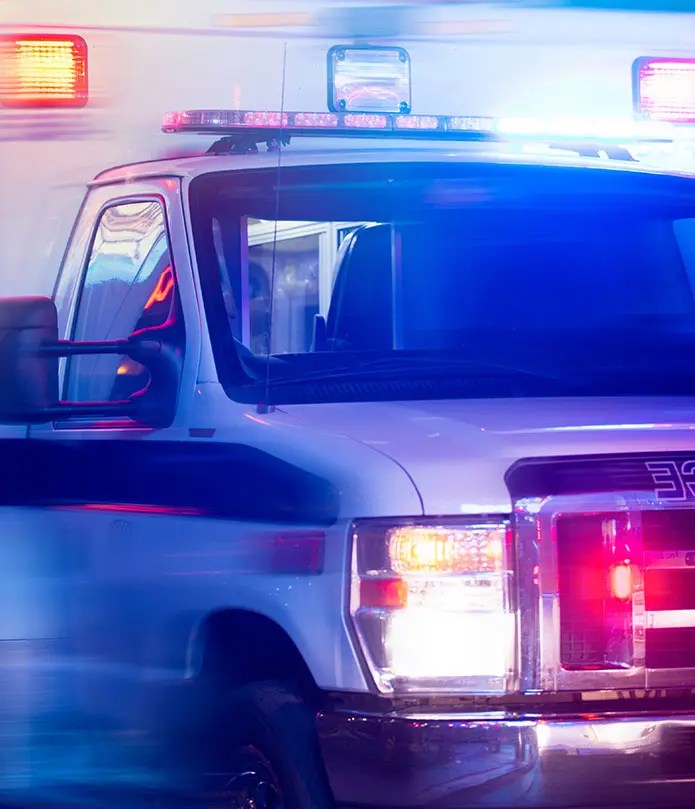 Ambulance with emergency lights used to represent EMT program training and BPPE requirements in the Bay EMT case study.