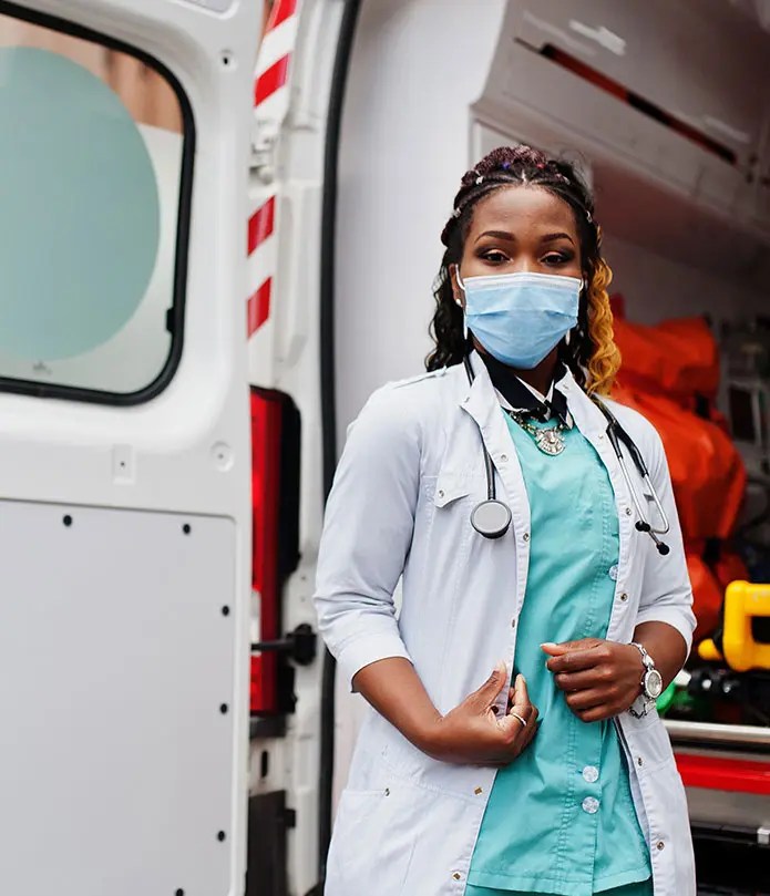 EMT trainee standing beside an ambulance, symbolizing hands-on learning and BPPE requirements for EMT programs.