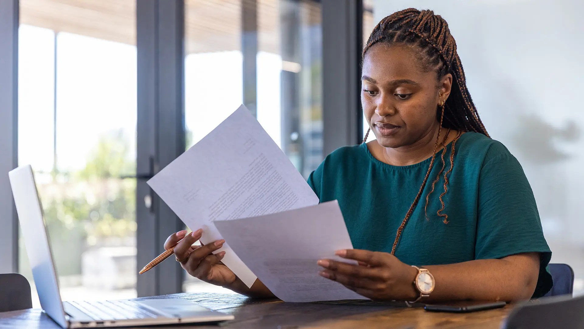School owner reviewing California school approval documents at a desk, representing the secondary agency approval consulting process.