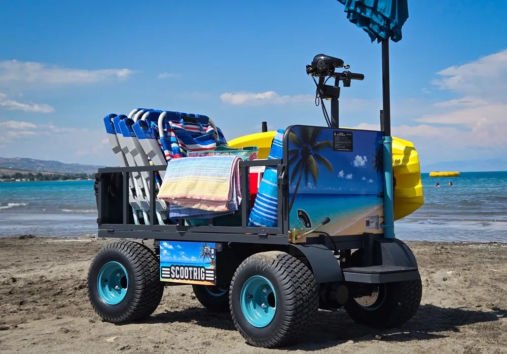 ScootRig BC-1000 beach cart with wide sand tires carrying beach equipment.