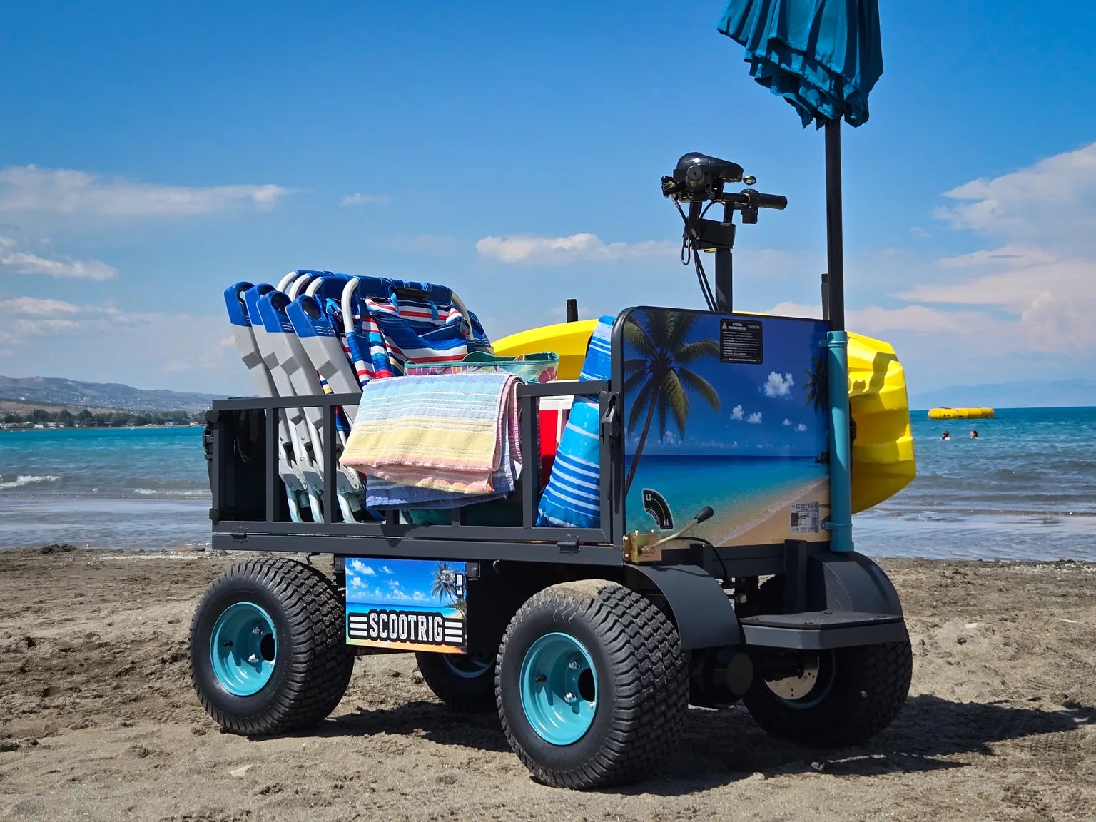 Authentic ScootRig BC-1000 beach cart loaded with chairs, towels, a kayak, and beach gear.