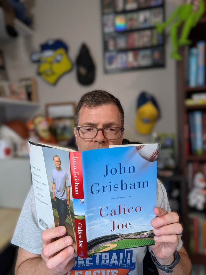 Scott reading Calico Joe by John Grisham
