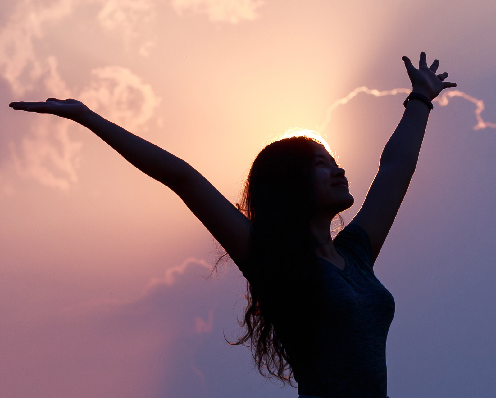 Happy confident Asian woman raising her hands up relax on summer vacation time, carefree girl being in nature, freedom people. By butsaya33