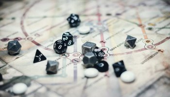 black and gray dice on white board game