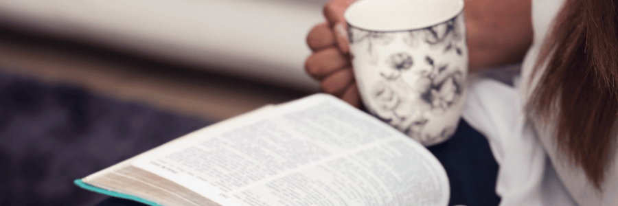 Cup of team and Bible