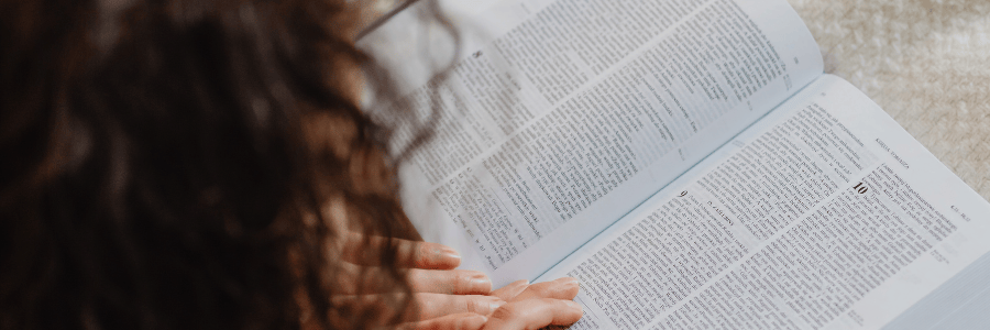 Why do we read and hear the Bible - woman reading open Bible