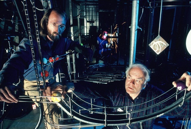 George Rhoads (bottom right) examines one of his sculptures