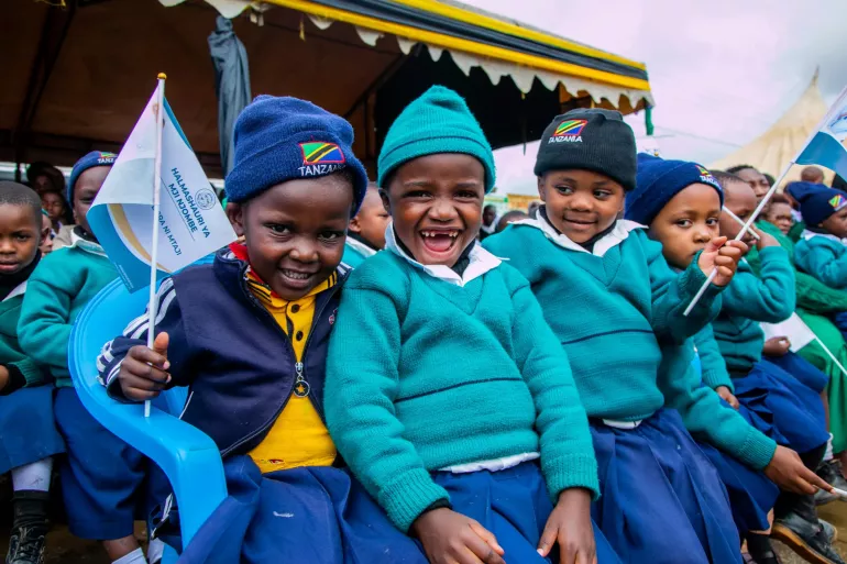 School girls at cheering at the Tanzania UNICEF campaign Volunteering Community-Based Activity