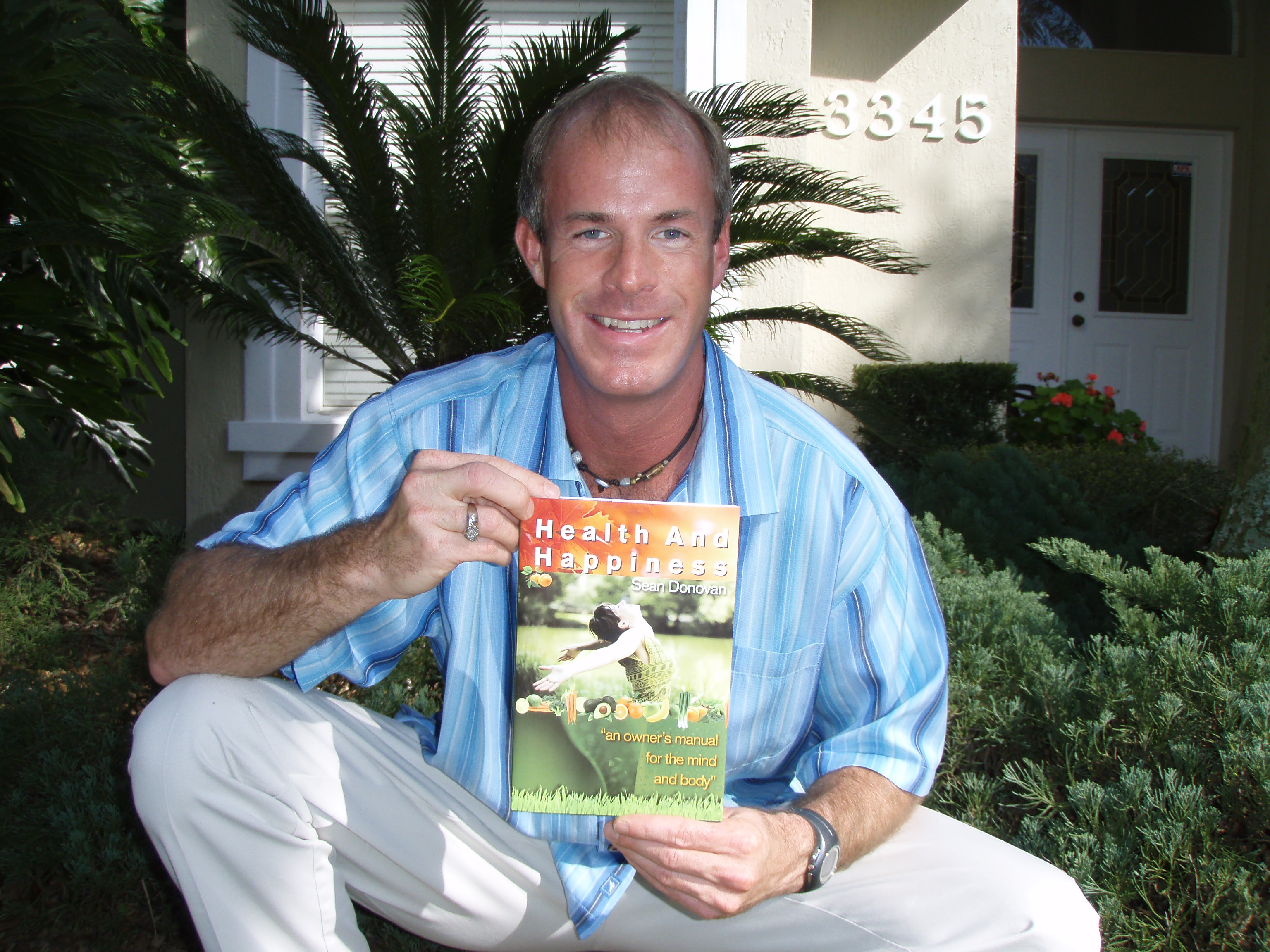 Sean Donovan holding the first copy of his first book, "Health and Happiness: an owner's manual for the mind and body"