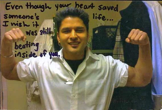 A photo of a person flexing their muscles with a reflective message written beside them.