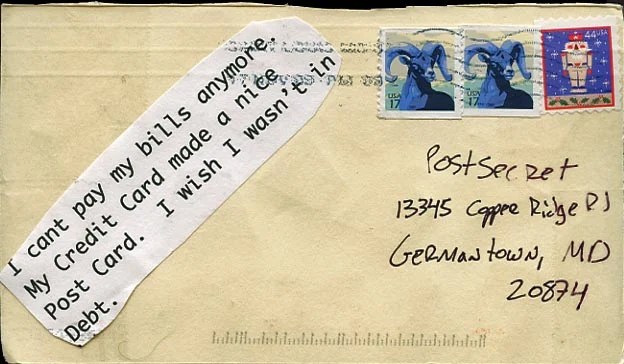 A handwritten note on a postcard expressing financial distress.