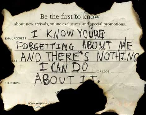 A torn note with handwritten text expressing feelings of being forgotten.