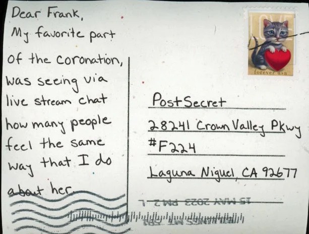 A handwritten note on a postcard with a cat stamp.