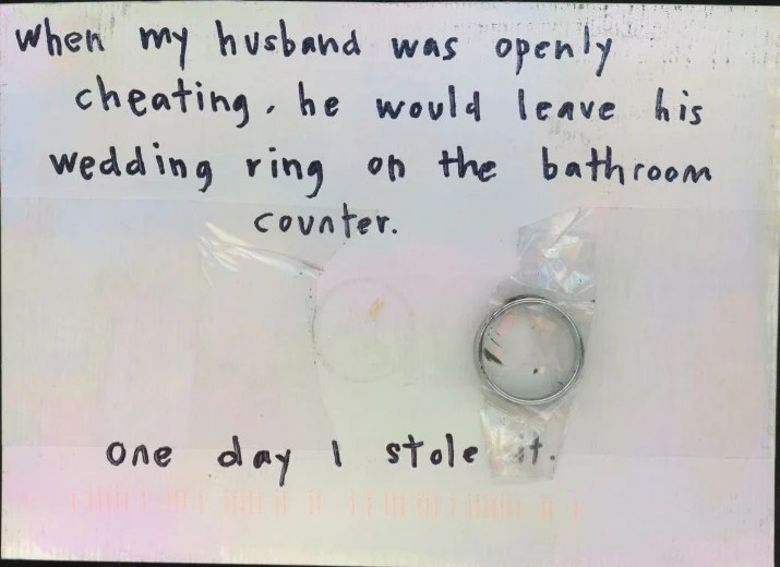 The front features handwritten text on a white background with a wedding ring taped to it.