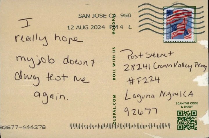 A handwritten message on a postcard with a postal stamp.